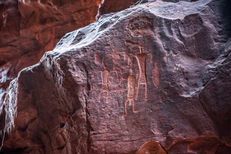 Ancient Nabatean and Thamudic inscriptions on rock representing camel caravan and humans. Khazali canyon, Wadi Rum desert, Jordanの写真素材
