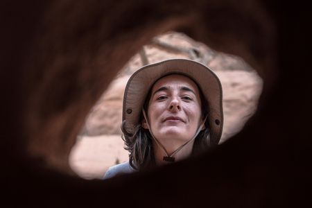 Woman posing in front of a small caveの写真素材