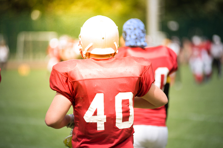 American Football players in action in the field. Sun flare effectの写真素材