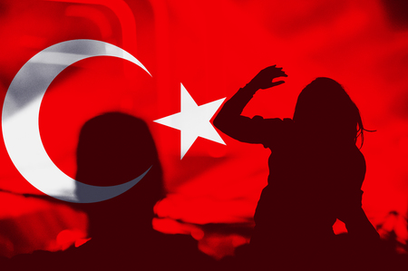 Crowd of people with raised arms over blending Turkey flagの写真素材