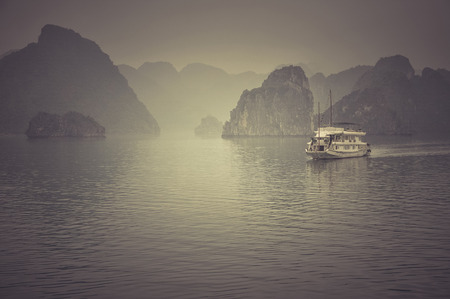 Misty Halong bay (Ha Long), Vietnam, in a rainy day. Filtered and toned imageの写真素材