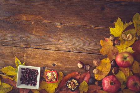 Autumn still life concept background. Fall leaves, harvest goodies on table top. Space for text, Thanksgiving postcardの写真素材