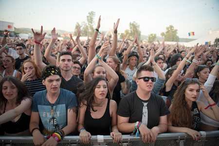 BONTIDA, ROMANIA - JULY 21, 2018: Crowd of cheerful fans dancing and partying during a Subcarpati live concert at Electric Castle festivalのeditorial素材