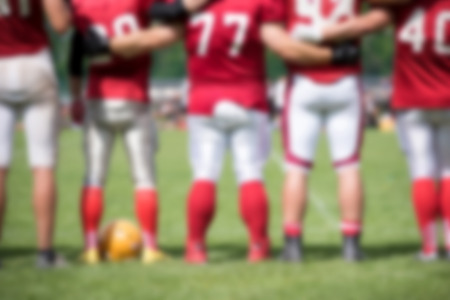 Blurred American football players in action during a matchの写真素材