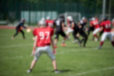 Blurred American football players in action during a matchの写真素材