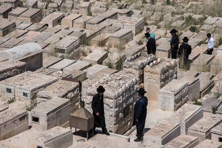 JERUSALEM, ISRAEL - MAY 16, 2018: Orthodox Jews  visiting the graveyards in the Jewish Cemetery on the Mount of Olivesのeditorial素材