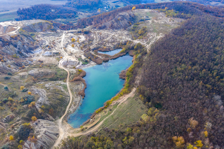 Drone view of industrial opencast mine filled with water. Aerial shot of artificial lakeの写真素材
