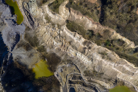 Abandoned industrial mining area. Drone view of opencast mine filled with water. Aerial shot of...