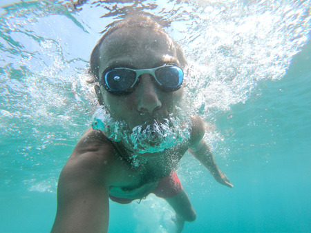 Man swimming underwater in the seaの写真素材