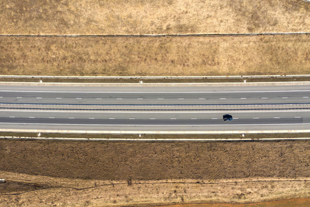 Aerial top view of cars and trucks passing on a highway, drone shot