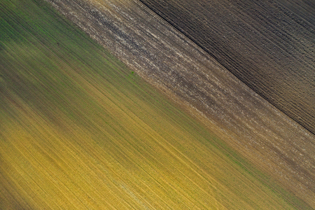 Aerial view of bio based industry and agriculture, plowed terrain in the spring from droneの写真素材