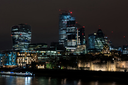 LONDON, UK - MARCH 22, 2019: The financial district of the town is called City of London and is illuminated every night by modern lightning systemsのeditorial素材