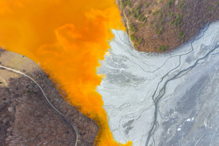 Aerial drone view of water pollution of a copper mine exploitation. Chemical residuals flooded...