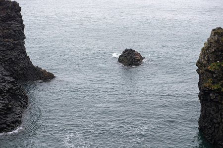 Gatklettur arch basalt rocks formation at the coast of Atlantic Ocean in Arnarstapi in Icelandの写真素材
