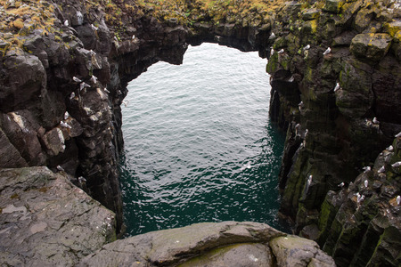 Gatklettur arch basalt rocks formation at the coast of Atlantic Ocean in Arnarstapi in Icelandの写真素材