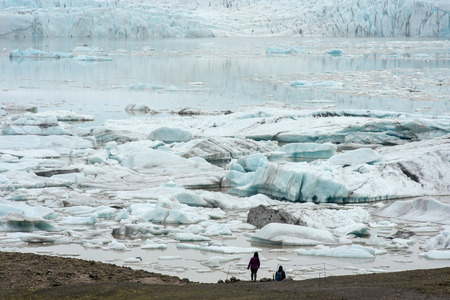 Floating icebergs drifting in the water in Fjallsarlon glacier lagoon, Vatnajokull National Park,...