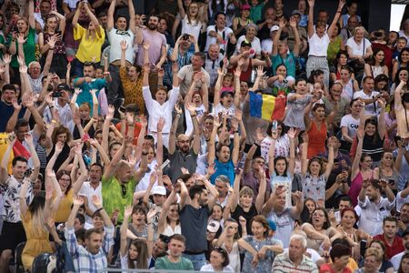 CLUJ, ROMANIA - JUNE 15, 2019: Crowd of people, tennis fans in the tribune supporting their...