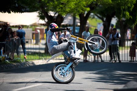CLUJ, ROMANIA - JUNE 16, 2019: Legendary motorcyclist Chris Pfeiffer stunt riding doing a demonstration with a BMW electric motion bike at Sports Festivalのeditorial素材