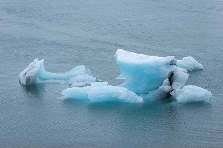 Melting icebergs as a result of global warming and climate change floating in Jokulsarlon glacial...