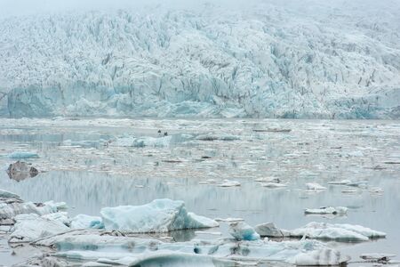 Floating icebergs drifting in the water in Fjallsarlon glacier lagoon, Vatnajokull National Park,...