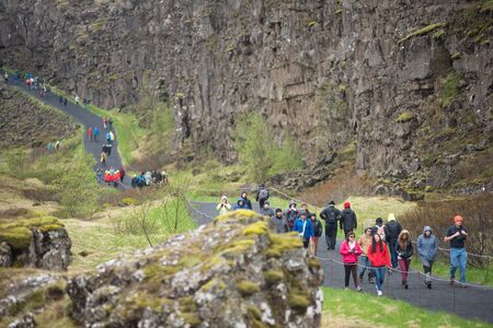 THINGVELLIR, ICELAND - MAY 20, 2019: Crowd of tourists visiting Thingvellir National Park a site of historical, cultural, and geological significanceのeditorial素材
