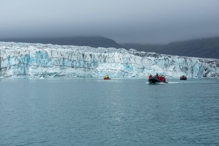 JOKULSARLON, ICELAND - MAY 23, 2019: Tourists taking a boat trip on Jokulsarlon glacial lagoon