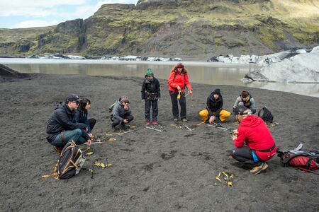 SOLHEIMAJOKULL, iCELAND - MAY 21, 2019: Tourists making a glacier hiking with a private tour guide in the Solheimajokull, Icelandのeditorial素材