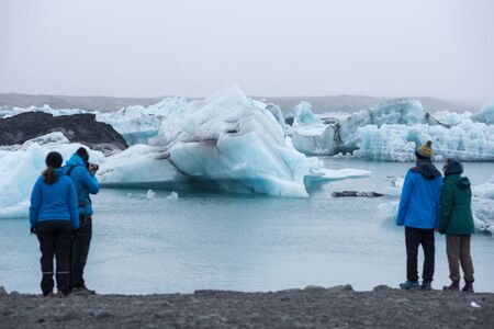 JOKULSARLON, ICELAND - MAY 22, 2019: Tourists admiring and photographing the melting icebergs in the Jokulsarlon glacial lagoonのeditorial素材
