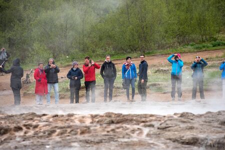 STROKKUR GEYSER, ICELAND - MAY 20, 2019: Tourists visiting and waiting for the eruption of Strokkur geyser in the Golden Circle of Icelandのeditorial素材