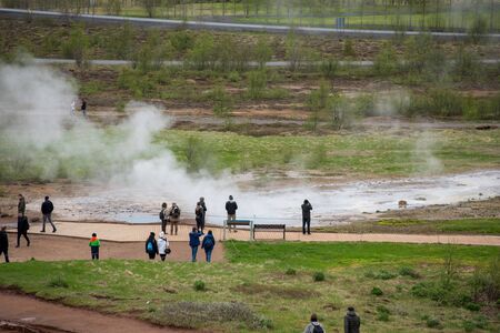STROKKUR GEYSER, ICELAND - MAY 20, 2019: Tourists visiting and waiting for the eruption of Strokkur geyser in the Golden Circle of Icelandのeditorial素材