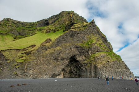 VIK, ICELAND - MAY 21, 2019: Tourists visiting the Reynisfjara beach and the basalt columns on the Atlantic coast of Southern Iceland in Vikのeditorial素材