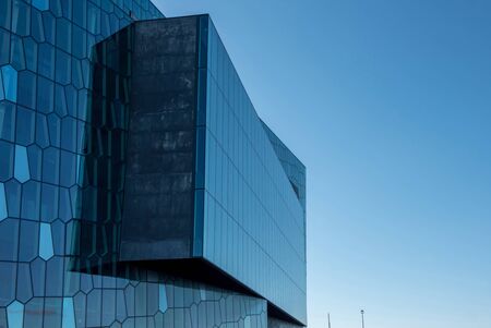 REYKJAVIK, ICELAND - MAY 24, 2019: The Harpa Concert Hall building features a distinctive colored...