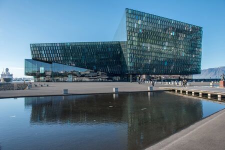 REYKJAVIK, ICELAND - MAY 24, 2019: The Harpa Concert Hall building features a distinctive colored glass facade inspired by the basalt landscape of Icelandのeditorial素材