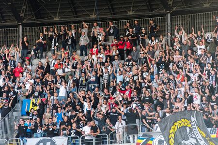 CLUJ NAPOCA, ROMANIA - JULY 12, 2019: Crowd of soccer supporters of U Cluj supporting their favorite football team in the tribune during a match against PAOK Salonikiのeditorial素材