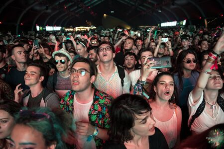 BONTIDA, ROMANIA - JULY 19, 2019: Crowd of cheerful people dancing and partying during a Sofi Tukker...
