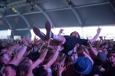 BONTIDA, ROMANIA - JULY 20, 2019: Rocker guy doing crowd-surfing during a While She Sleeps rock concert at Electric Castle festivalのeditorial素材