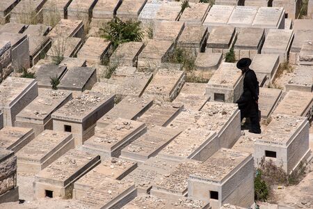 JERUSALEM, ISRAEL - MAY 16, 2018: Orthodox Jew  visiting the graveyards in the Jewish Cemetery on...