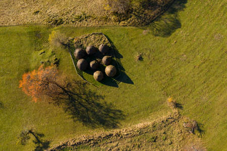 Group of autumn haystacks in a meadow, aerial above drone view