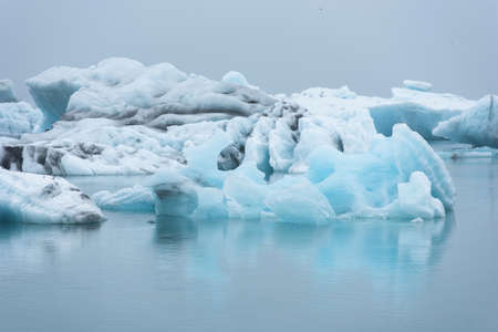 Melting icebergs as a result of global warming and climate change floating in Jokulsarlon glacial...