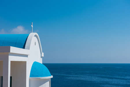 Traditional Greek white chapel with a blue roof on the seaside. Agioi Anargyroi chapel, Cyprusの写真素材
