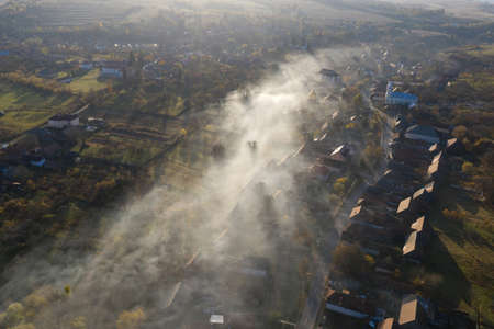 Aerial drone view of morning haze and mist above village houses. Manastireni, Romaniaの写真素材