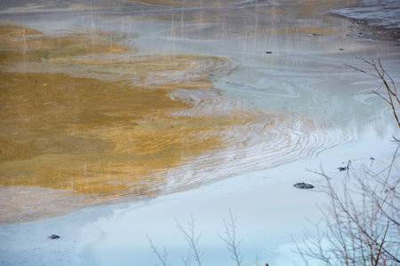 Muddy waters in a decantation pond. Toxic residuals from a copper mine decating in a settling basin. Geological industrial mining landscape. Geamana, Rosia Montana, Romaniaの写真素材