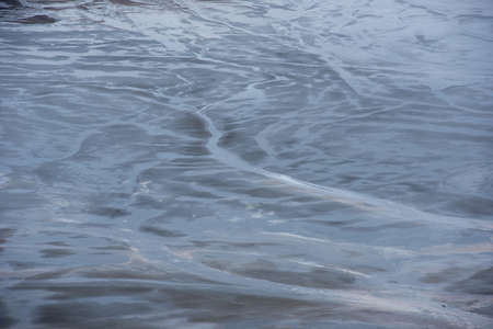 Muddy waters in a decantation pond. Toxic residuals from a copper mine decating in a settling basin. Geological industrial mining landscape. Geamana, Rosia Montana, Romaniaの写真素材