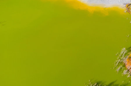 Aerial drone view of a huge decanting lake. Background of green residuals from a copper mine. Geamana, Romaniaの写真素材