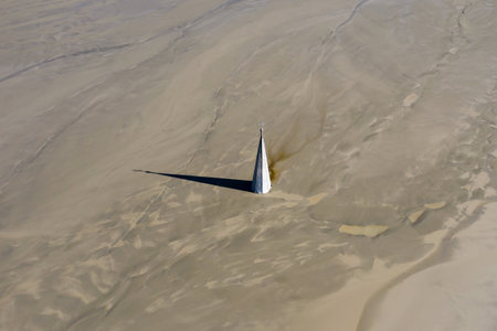 Aerial apocalyptic scene, church tower with cross buried under mud and toxic copper mining residuals. Geamana, Romaniaの写真素材