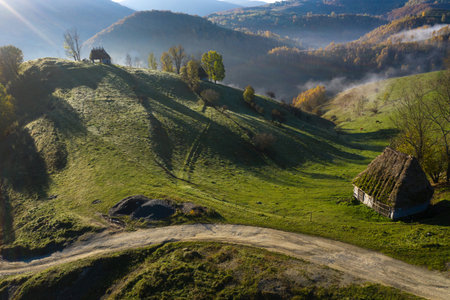 Aerial view of a mountain homestead in the autumn in early morning lights. Transylvania, Romaniaの写真素材