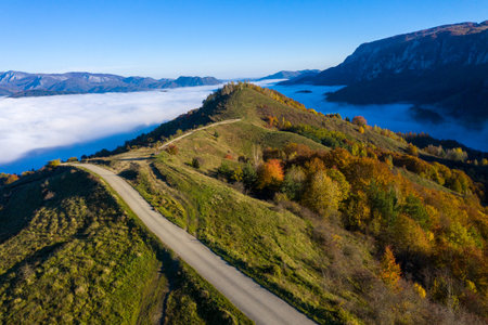 Morning haze in the mountains. Aerial drone view of autumn countryside hills in Transylvania, Romaniaの写真素材