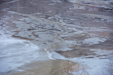 Muddy waters in a decantation pond. Toxic residuals from a copper mine decating in a settling basin. Geological industrial mining landscape. Geamana, Rosia Montana, Romaniaの写真素材