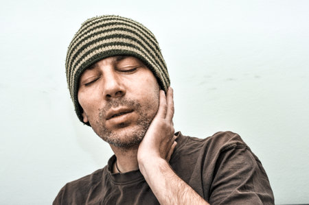 Dental problems. Portrait of unhealthy man with swollen face suffering acute toothache painの写真素材
