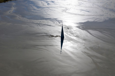 Aerial view of silhouette of church tower with cross, buried under mud and mining residuals....